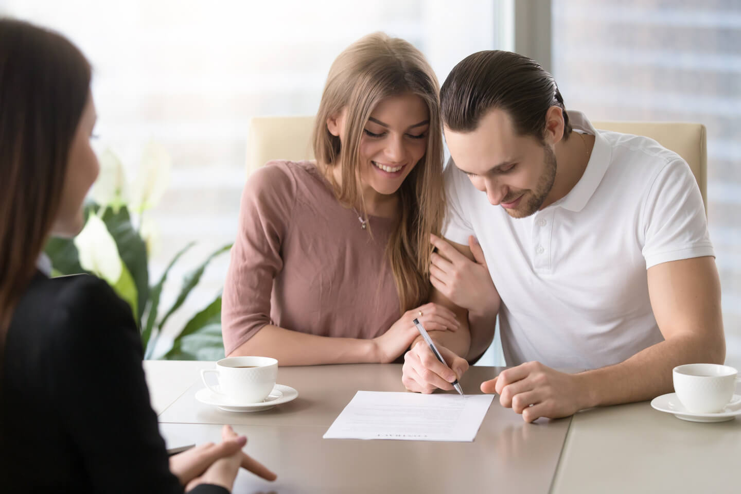 Smiling couple agreed to sign a loan contract