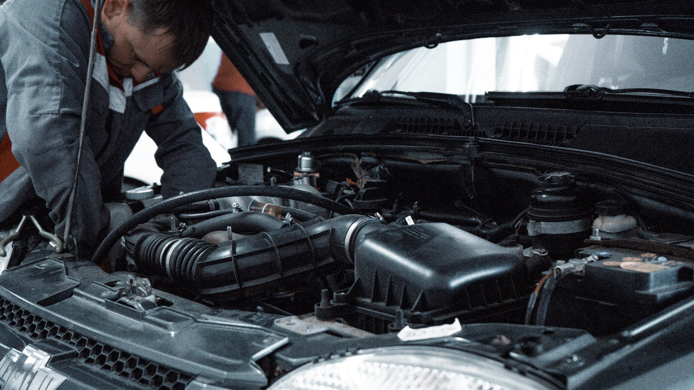 A mechanic looking at a cars condition